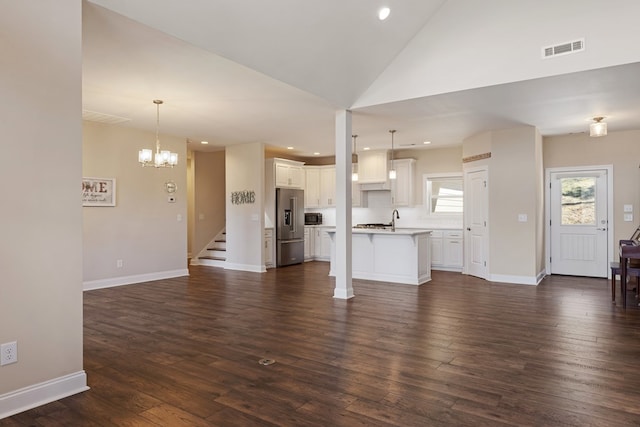 unfurnished living room featuring visible vents, dark wood finished floors, stairway, recessed lighting, and a sink