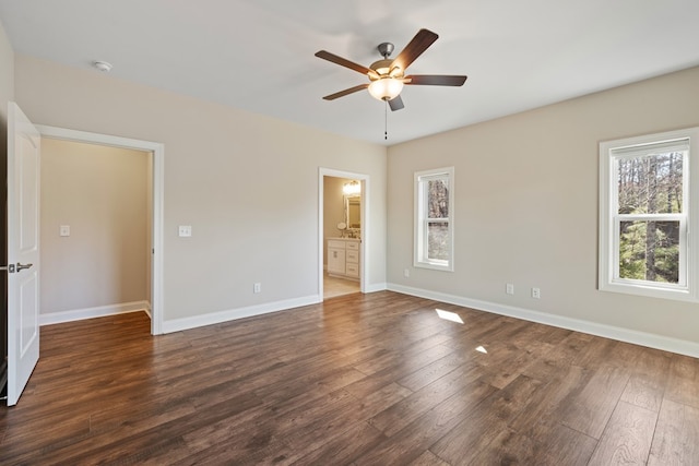 spare room featuring dark wood-type flooring, baseboards, and ceiling fan