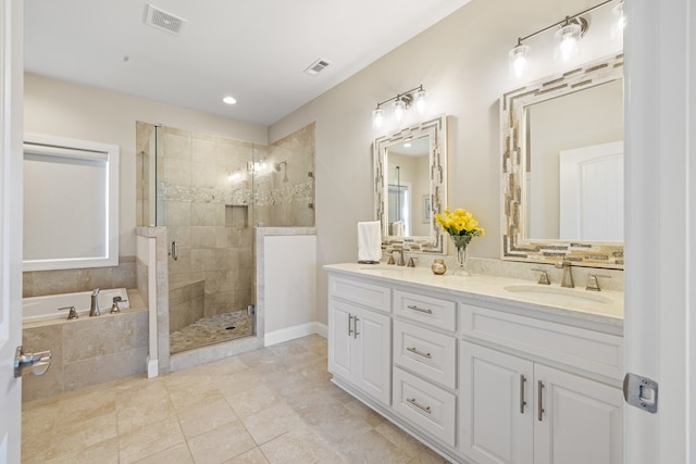 bathroom with a sink, visible vents, a garden tub, and a stall shower