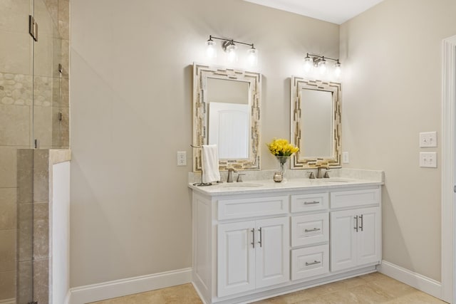 bathroom with a shower stall, baseboards, and a sink