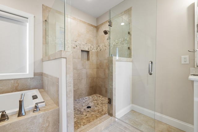 bathroom featuring tile patterned floors, a garden tub, and a stall shower