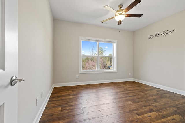 spare room featuring hardwood / wood-style floors, baseboards, and ceiling fan