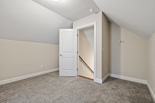 bonus room featuring baseboards, carpet, and vaulted ceiling