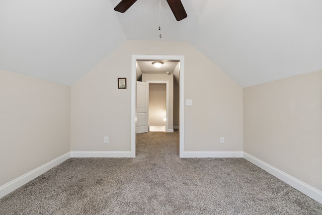 additional living space featuring lofted ceiling, carpet flooring, a ceiling fan, and baseboards