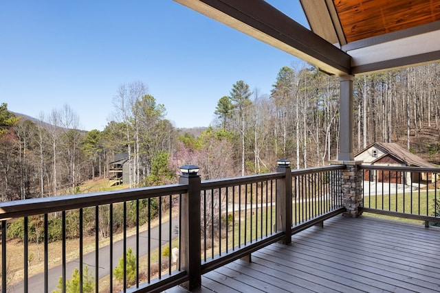 wooden deck featuring a forest view