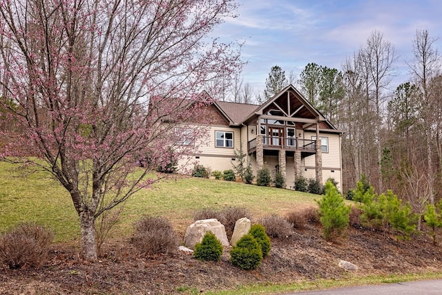 view of front of property with a balcony and a front yard