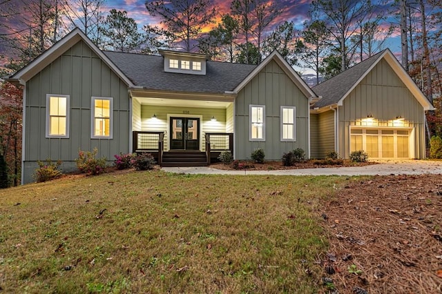 view of front facade with a yard and a garage