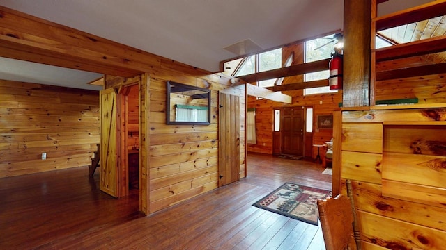 hall with wooden walls and hardwood / wood-style flooring