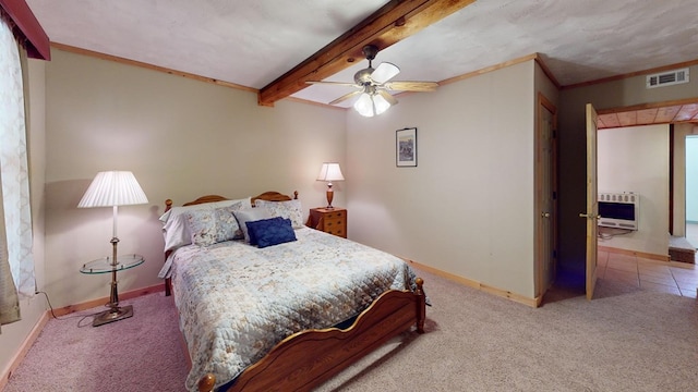 bedroom featuring visible vents, carpet, heating unit, and beamed ceiling