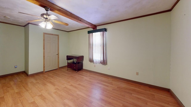 spare room featuring baseboards, light wood-style flooring, and ceiling fan