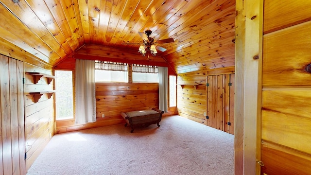 living area with carpet floors, wood walls, a ceiling fan, wooden ceiling, and vaulted ceiling