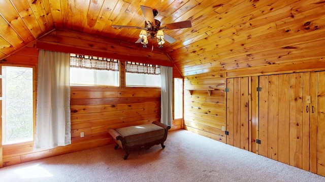 unfurnished room featuring plenty of natural light, lofted ceiling, and wooden walls