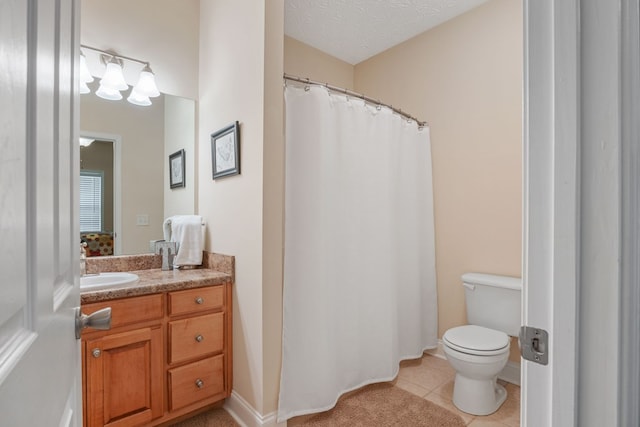 bathroom with vanity, toilet, tile patterned flooring, and a textured ceiling