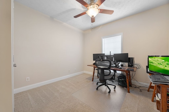 office featuring light colored carpet, ceiling fan, and a textured ceiling