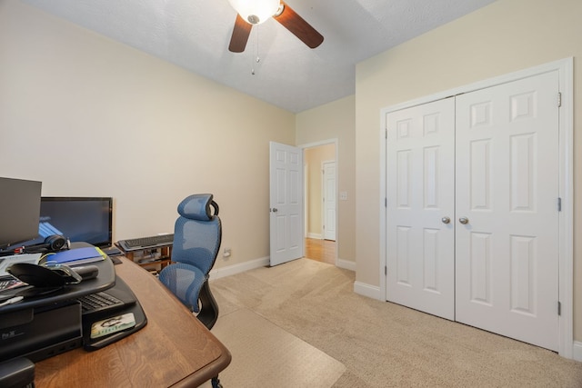 home office with ceiling fan, light colored carpet, and a textured ceiling