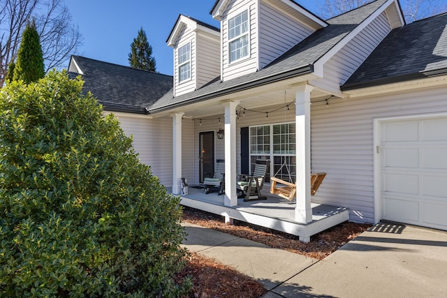 entrance to property featuring a garage and covered porch