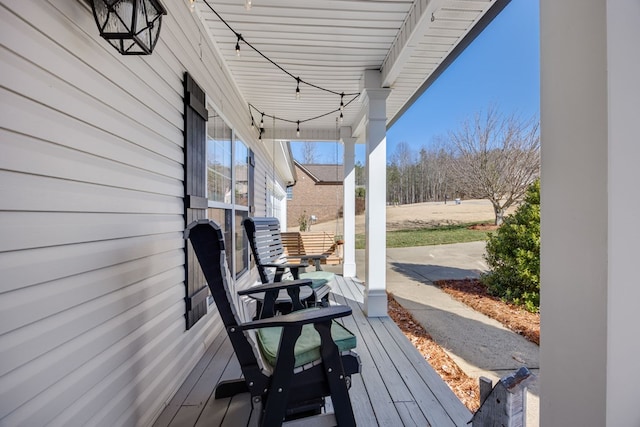 wooden terrace with a porch