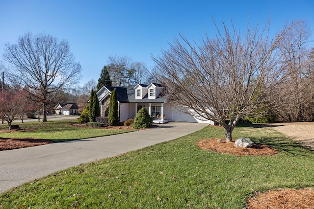 view of front of home with a front lawn and a garage