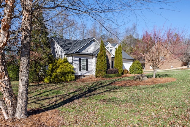 view of home's exterior with a yard and a garage