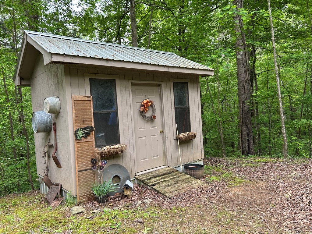 view of outbuilding with a wooded view
