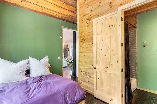 bedroom featuring baseboards and dark wood-style floors