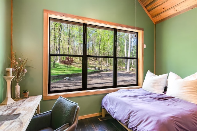 bedroom featuring baseboards, wood ceiling, lofted ceiling, and multiple windows