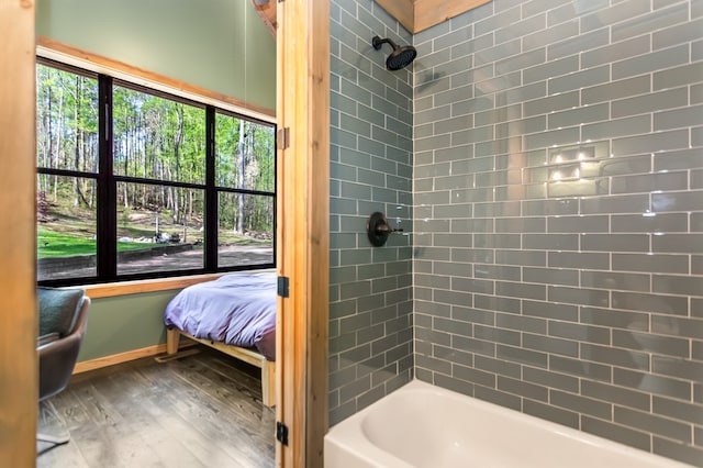 full bathroom with shower / bath combination, baseboards, and wood finished floors