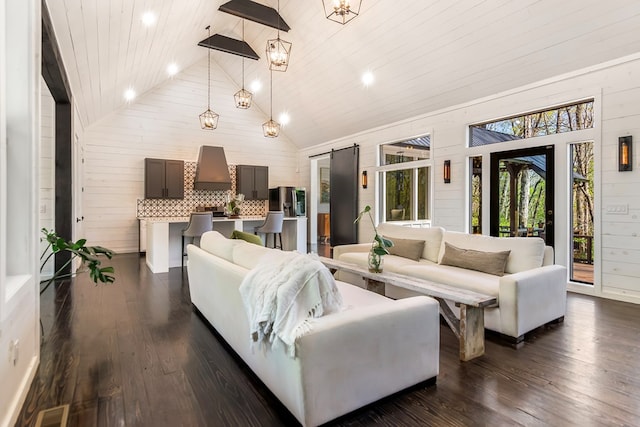 living area featuring wood ceiling, high vaulted ceiling, wood walls, and a wealth of natural light