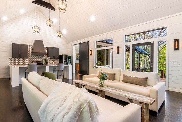 living area with dark wood-type flooring, recessed lighting, wooden walls, and high vaulted ceiling