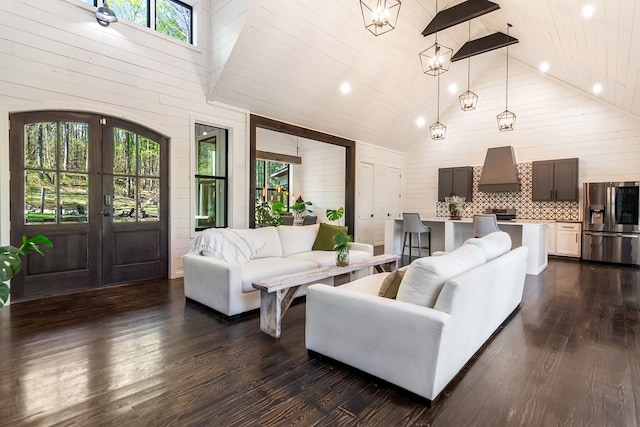 living area featuring wooden walls, high vaulted ceiling, recessed lighting, and dark wood-type flooring