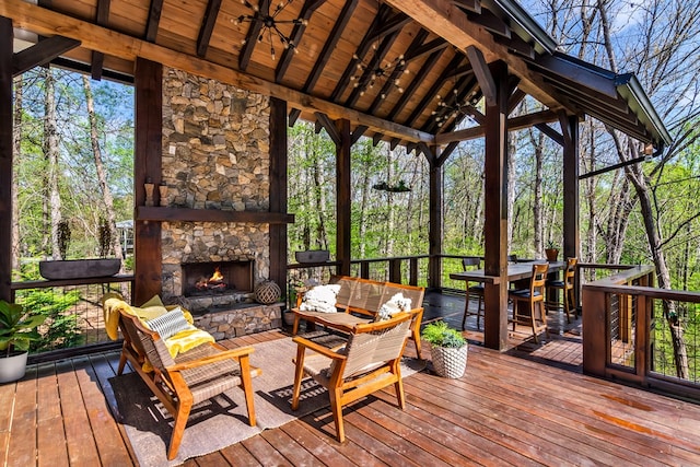 deck with an outdoor living space with a fireplace