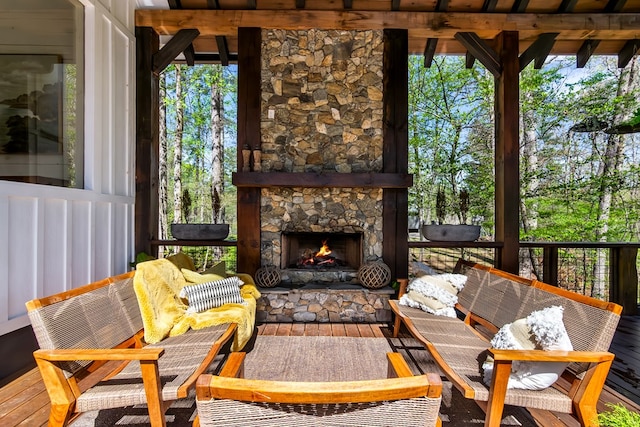 sunroom / solarium featuring an outdoor living space with a fireplace