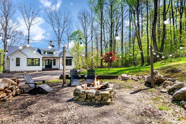 view of yard with an outdoor fire pit
