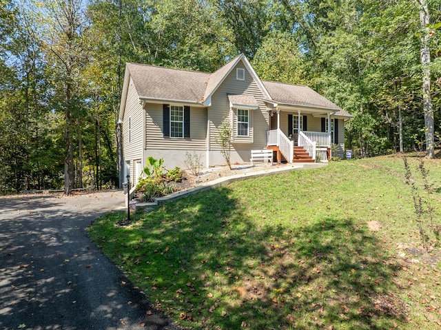 view of front facade featuring a front lawn, a porch, and a garage