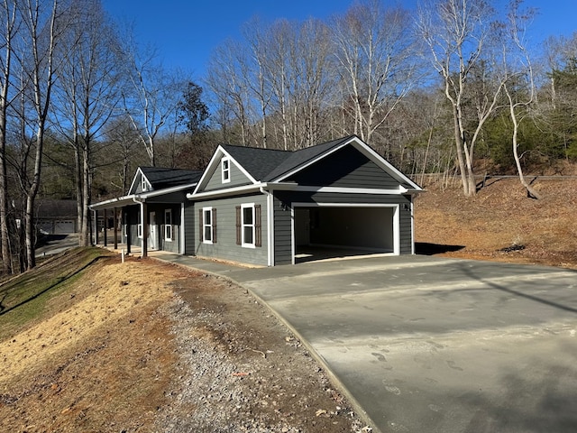 view of home's exterior with covered porch and a garage