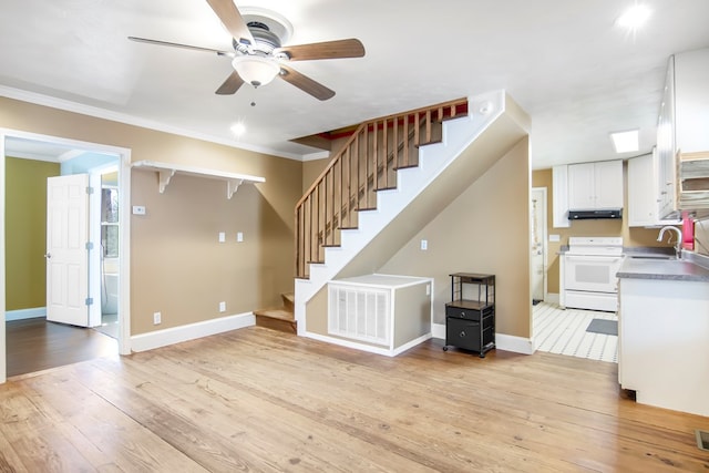 1575 Old Burnt Mountain Rd, Jasper, GA 30143 - unfurnished living room featuring a sink, ceiling fan, stairway, ornamental molding, and light wood-style flooring
