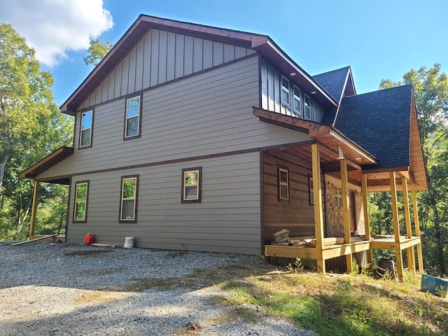 view of side of home featuring covered porch