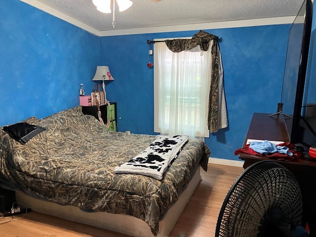 bedroom featuring hardwood / wood-style floors and a textured ceiling