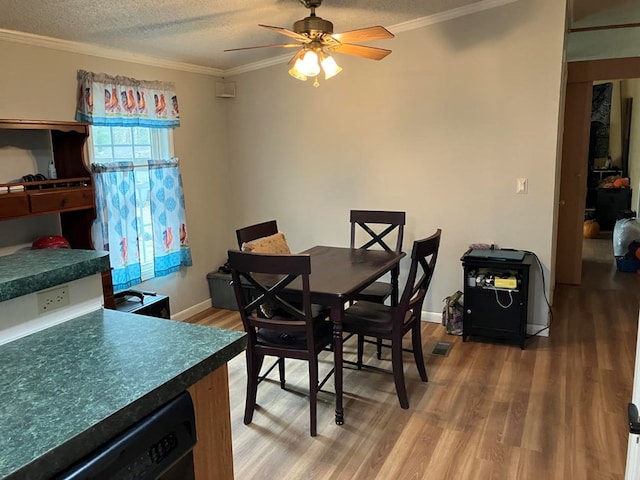 dining room featuring a textured ceiling, ceiling fan, and crown molding