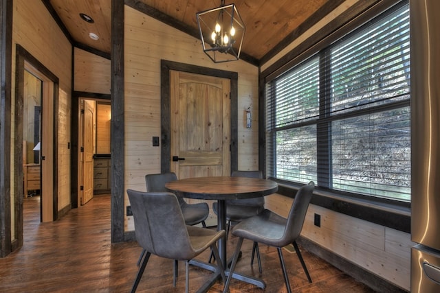 dining room featuring a notable chandelier, wood walls, wood ceiling, and vaulted ceiling