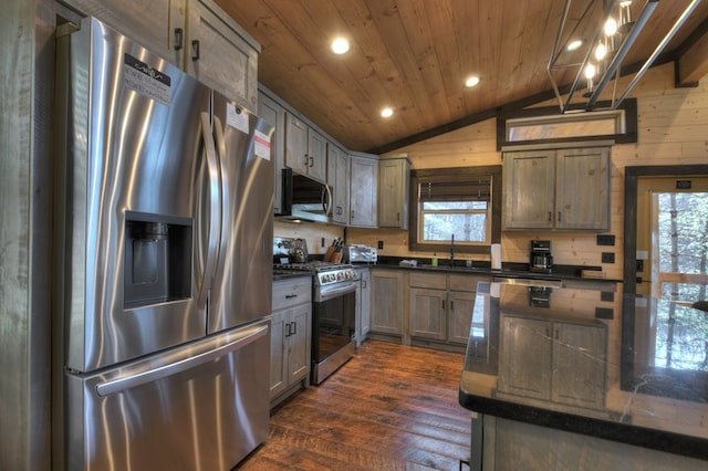 kitchen featuring appliances with stainless steel finishes, dark hardwood / wood-style flooring, vaulted ceiling, sink, and wooden ceiling