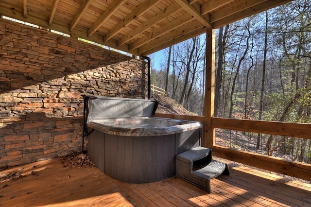 wooden terrace featuring a hot tub