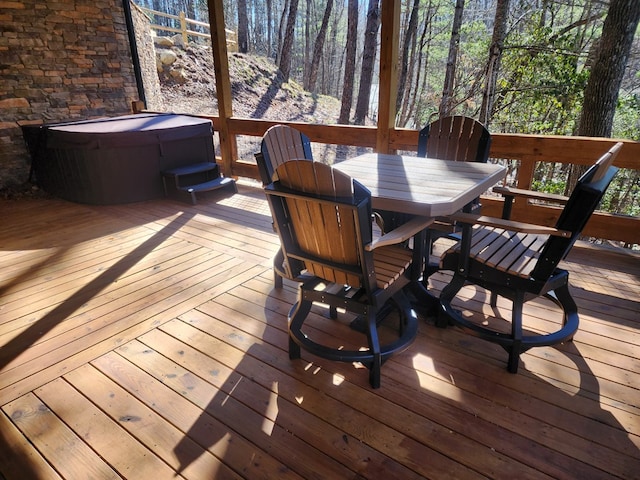 wooden deck featuring a hot tub