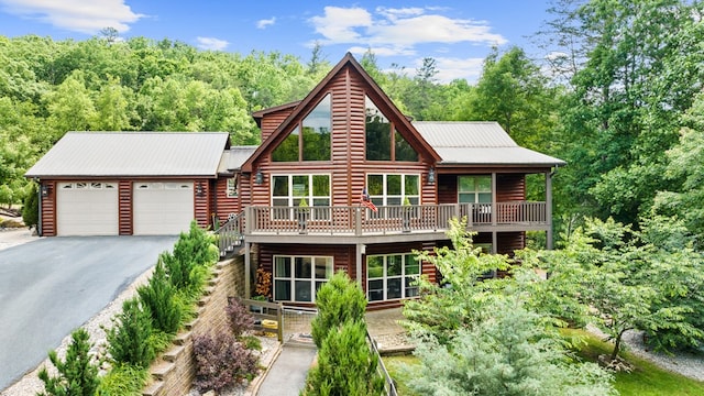 cabin with a balcony and a garage