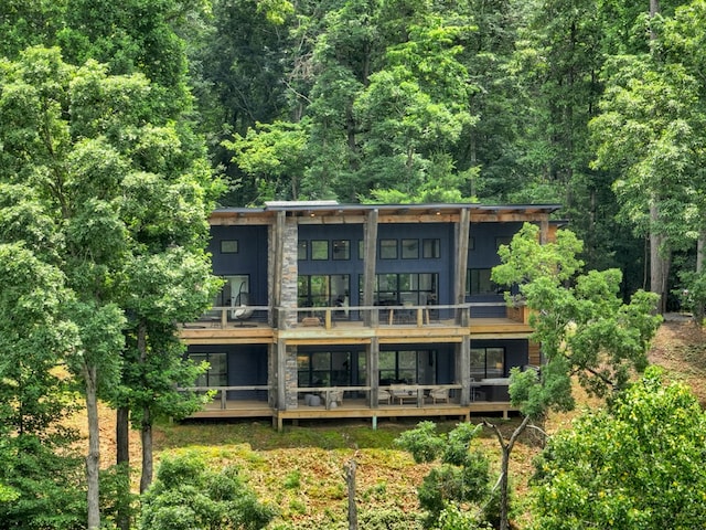 897 Faraday Dr, Ellijay, GA 30540 - back of house featuring a balcony and a wooded view