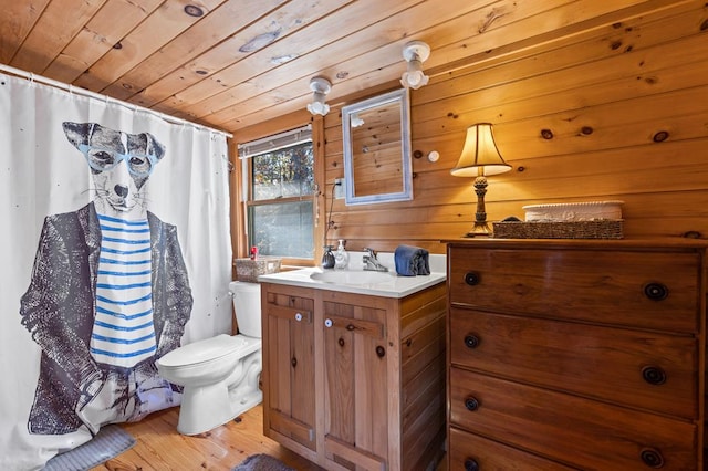 bathroom featuring toilet, wood finished floors, vanity, wooden ceiling, and a shower with shower curtain