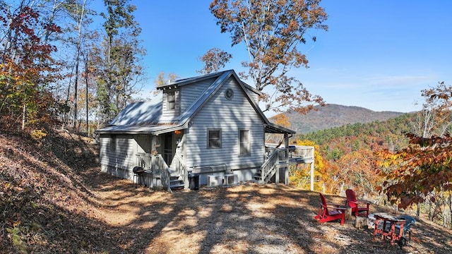 view of side of property with central air condition unit, stairs, and a mountain view