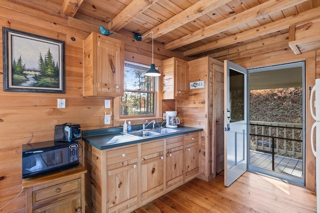 kitchen with wood ceiling, light wood-style flooring, dark countertops, beamed ceiling, and black microwave