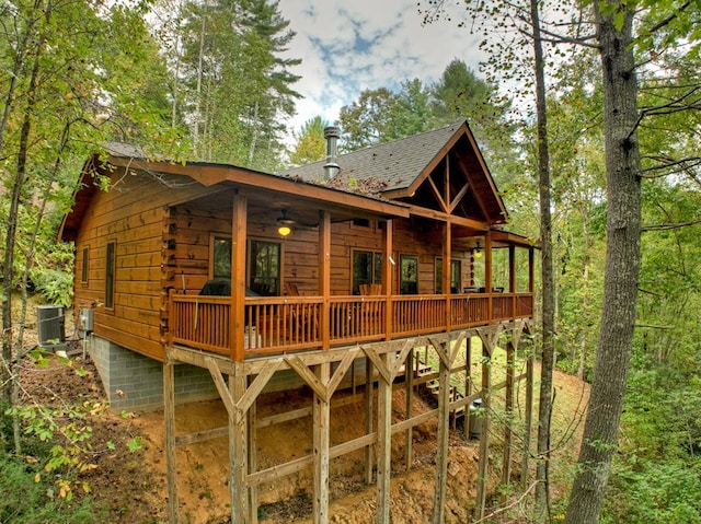 back of house with ceiling fan, a wooden deck, and central AC