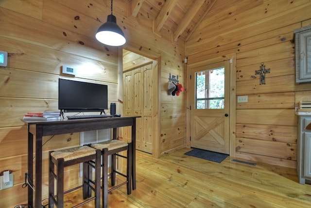 office with lofted ceiling with beams, wooden ceiling, wooden walls, and light hardwood / wood-style flooring